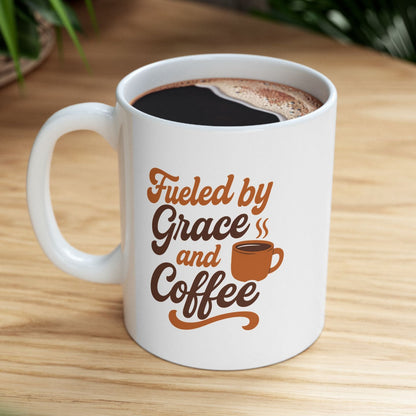 White mug with 'Fueled by Grace and Coffee' text on a wooden table